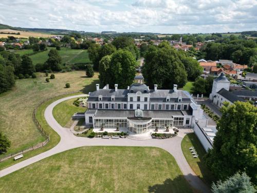 an aerial view of a large white mansion at Château de Ranchicourt in Ranchicourt