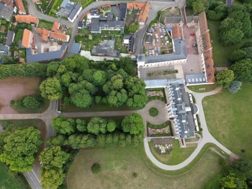an overhead view of a park with trees and buildings at Château de Ranchicourt in Ranchicourt