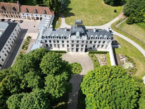 an aerial view of a building with trees at Château de Ranchicourt in Ranchicourt