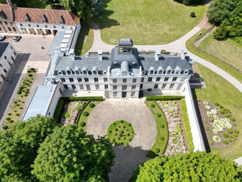 an aerial view of a building with a garden at Château de Ranchicourt in Ranchicourt