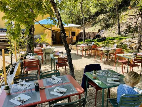 a child sitting at a table at a restaurant at Résid'Artel Cadarache - ITER in Saint-Paul-lez-Durance
