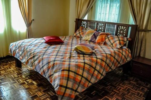 a bedroom with a bed with pillows on it at Nyari estate in Nairobi