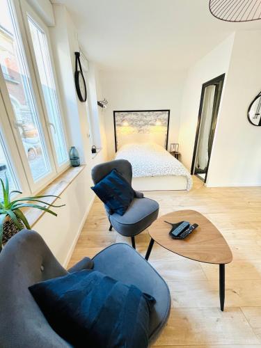 Cette chambre comprend un lit, deux chaises et une table. dans l'établissement BELLE TOUR, à Reims