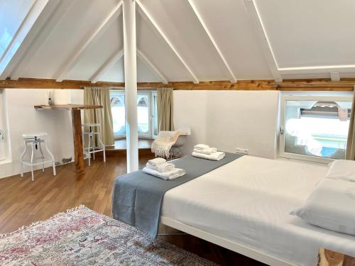 a bedroom with two beds with towels on them at Historic Rooms and Apartments in the City Centre of Bolzano in Bolzano