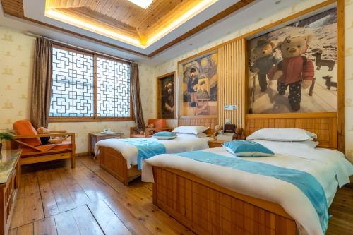 a bedroom with two beds and a painting on the wall at Mount Emei Teddy Bear Hotel玩具熊酒店 in Emeishan