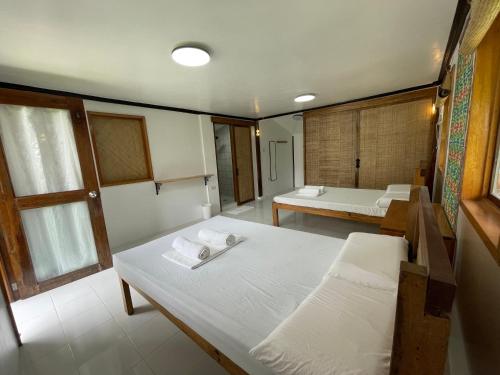 a small room with two beds and a room with at Dahun Villas Siargao in General Luna