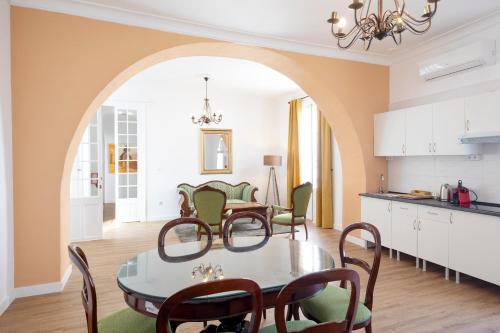 a kitchen and dining room with a table and chairs at PALACIO DON CARLOS in Jerez de la Frontera