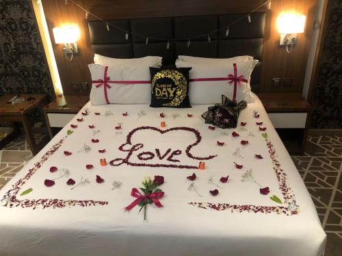 a bed with the words love written on it at Taj Al-Wajh Hotel in Al Wajh