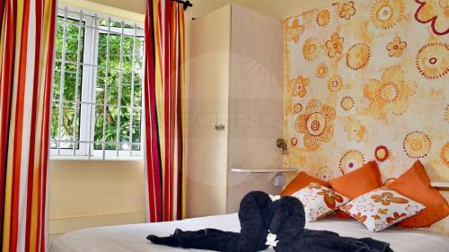 a bedroom with a bed with a stuffed animal on it at Perfect Escape - Oasis de calme à 300m de la plage in Poste Lafayette