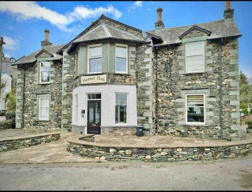 a stone house with a sign on the front of it at A charming luxury apartment! in Portinscale