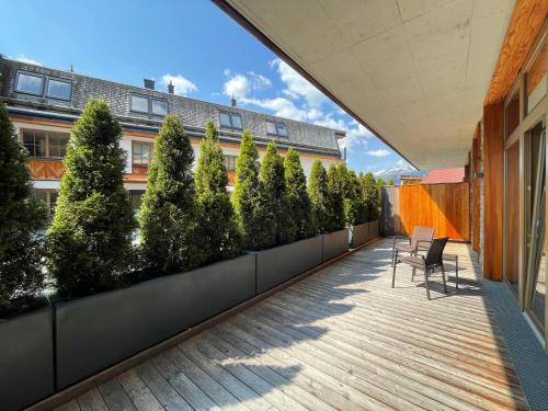 a rooftop garden with trees on a building at Mountain Spa Residences in Sankt Anton am Arlberg