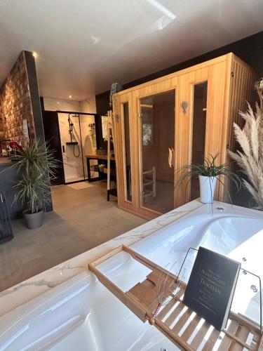 a bath tub with a sign in the middle of a room at Secret Place apartments, luxury and spa 