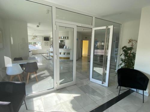 a room with glass doors and a table and chairs at Hotel Playamar Spa in Laredo