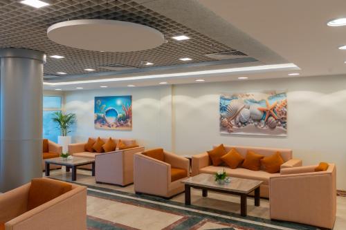 a waiting room at a hospital with couches and tables at Safir Marsa Matrouh Resort in Marsa Matruh
