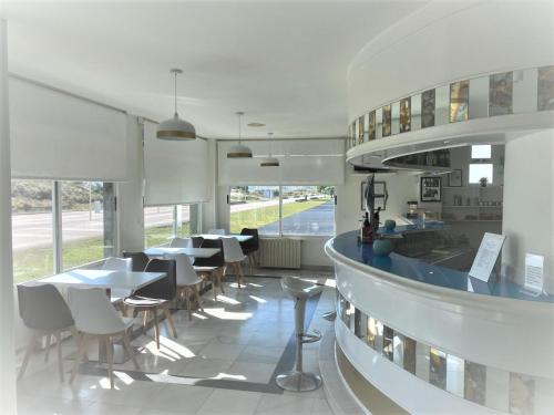 a restaurant with tables and chairs in a building at Hotel Playamar Spa in Laredo