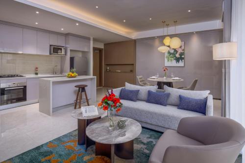 a living room and kitchen with a couch and a table at Pan Pacific Serviced Suites Nairobi in Nairobi