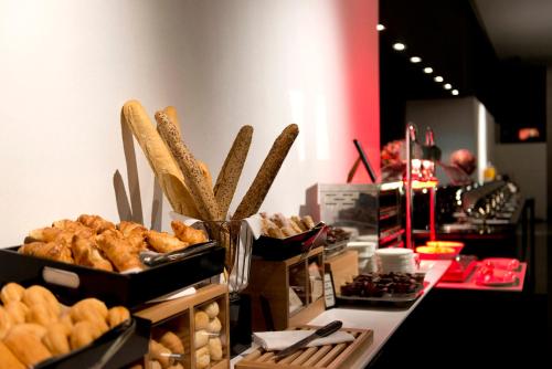 a buffet of bread and pastries on a table at Hilton Madrid Airport in Madrid
