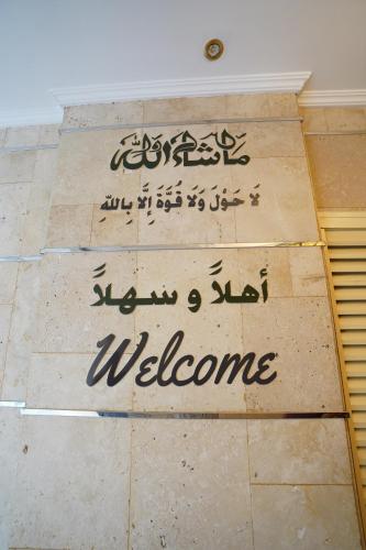 a sign that says welcome on a wall at Cube Hotel Dubai in Dubai