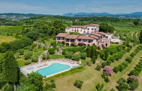 z góry widok na dużą posiadłość z basenem w obiekcie Castello Belvedere Apartments w mieście Desenzano del Garda