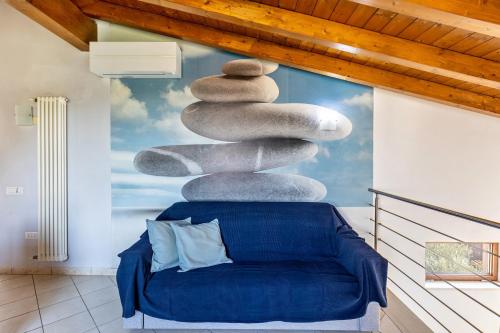 a stack of rocks sitting on top of a blue couch at Verona house in Verona