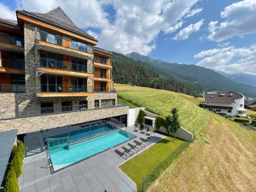 an aerial view of a house with a swimming pool at Mountain Spa Residences in Sankt Anton am Arlberg