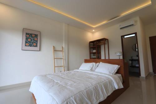 Postel nebo postele na pokoji v ubytování Kayom Rooms