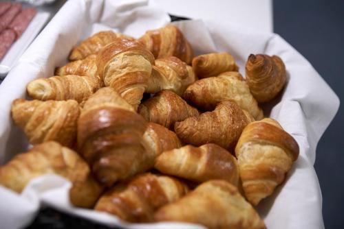 a plate of croissants and other pastries on a table at BB-Hotel Rønne Bornholm in Rønne