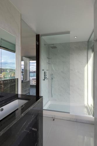 a bathroom with a glass shower and a sink at Doubletree By Hilton London - Greenwich in London