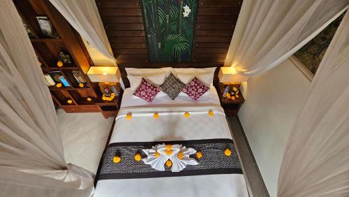 an overhead view of a bed in a room with curtains at Ubud Paradise Villa in Ubud