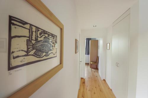 a hallway with a large painting on the wall at Appartement élégant avec terrasse privée in Villars-sur-Glâne