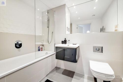 a white bathroom with a toilet and a sink at Luxury New 2 Bed/2 Bathroom Flat With Balcony in Edgware