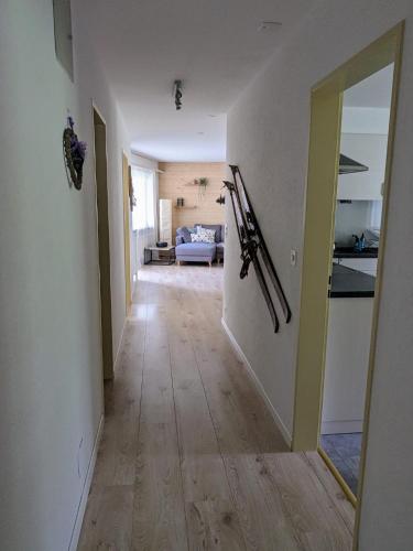 a hallway leading to a kitchen and a living room at Petit Trianon 1,3 - Grosses Familiennest komplett renoviert in Leukerbad