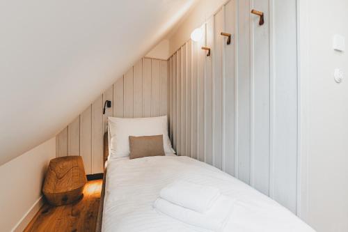 a small bedroom with a bed in the attic at Penzion KOVÁRNA in Český Krumlov