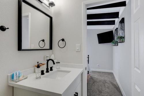 a white bathroom with a sink and a mirror at Lady Luck Oasis Large Pool Central Dogs Welcome in Las Vegas