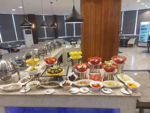 a buffet of food on a table in a restaurant at Taj Al-Wajh Hotel in Al Wajh