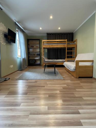 a bedroom with a bunk bed and a hard wood floor at Engure apartment "Little one" in Engure