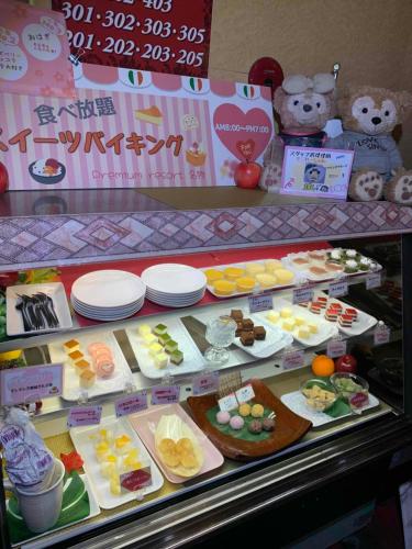 a display case filled with different types of desserts at premium resort nagoya in Nagoya