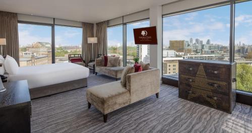 a hotel room with a bed and a large window at Doubletree By Hilton London - Greenwich in London