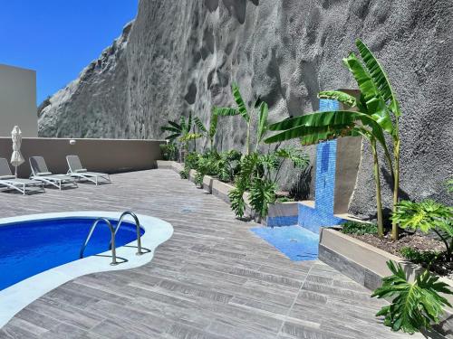 a resort with a pool in front of a mountain at Luxury Villa Ifara Private Heated Pool in Adeje