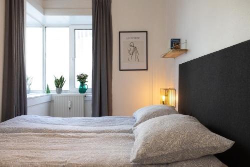 a bedroom with a large bed and a window at Stefania in Aalborg