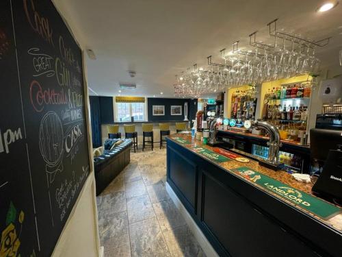 a bar in a restaurant with a counter and chairs at Rose & Crown Rooms in Beverley