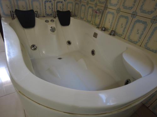 a large white bath tub in a bathroom at DANA KIGALI HOTEL in Kigali