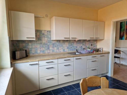 a kitchen with white cabinets and a sink at Gerburg Haus in Rinteln
