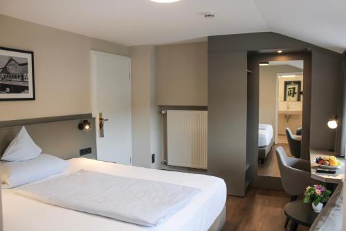 a hotel room with a bed and a table and chairs at Hotel Stockhausen GbR in Schmallenberg