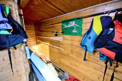 a inside of a kayak room with a wooden wall at Wyspa Ciernie - Dom nad jeziorem z sauną i jacuzzi in Ciernie