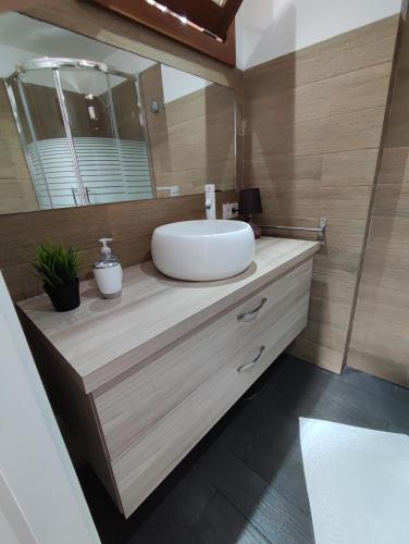 a bathroom with a sink and a mirror at House to relax El Tanque in Tanque