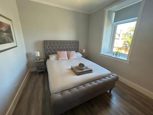 a bedroom with a bed with a tray on it at Castle Grant Apartment in Inverness