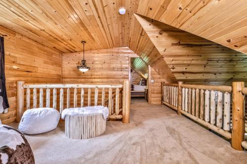 a log cabin with a crib in a room with wooden ceilings at Woodland Wonderland in Winchester