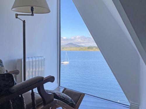 a room with a window with a view of the water at Apartment 454 - Roundstone in Roundstone