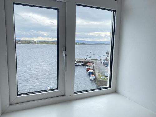 a window with a view of a body of water at Apartment 454 - Roundstone in Roundstone